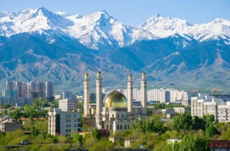 Comparison of modern luxury hotels and residential apartments in Almaty, Kazakhstan, with the Trans-Ili Alatau mountains in the background