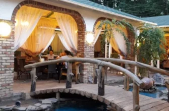 Elegant Almaty restaurant dining room with traditional Kazakh decor and panoramic city views