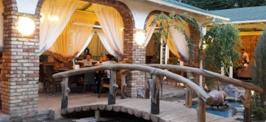 Elegant Almaty restaurant dining room with traditional Kazakh decor and panoramic city views