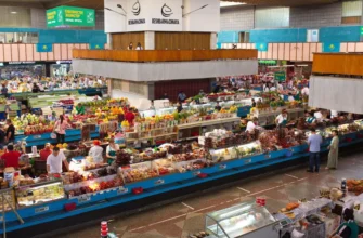Green Bazaar Almaty main pavilion with colorful produce displays and vendors