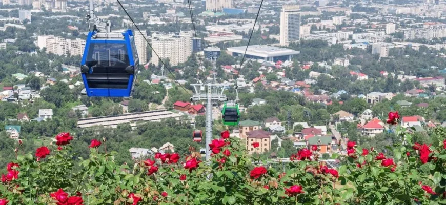 Scenic cable car ascending Kok-Tobe hill with panoramic views of Almaty city and Tien Shan mountains