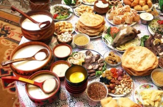 Traditional Kazakh food dastarkhan with beshbarmak, kazy horse sausage, and baursak bread